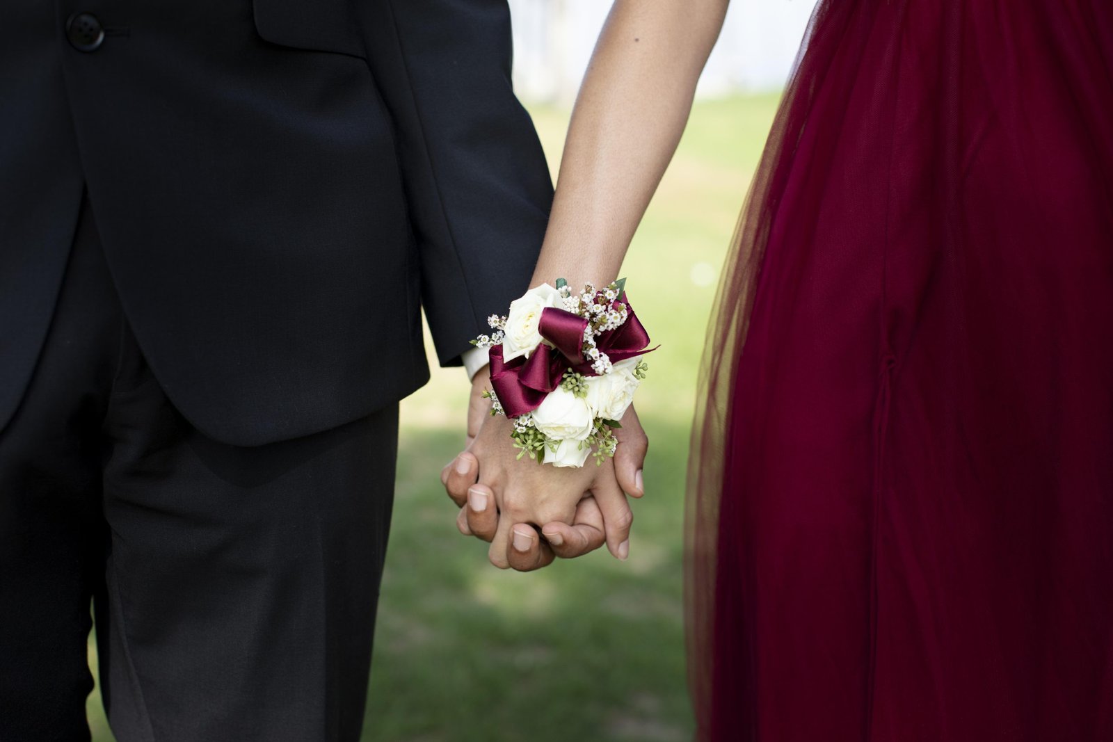 couple-graduation-prom-clothing-holding-hands